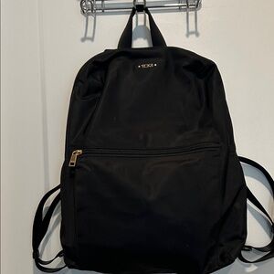 NWOT Tumi backpack. Black Nylon with gold hardware.